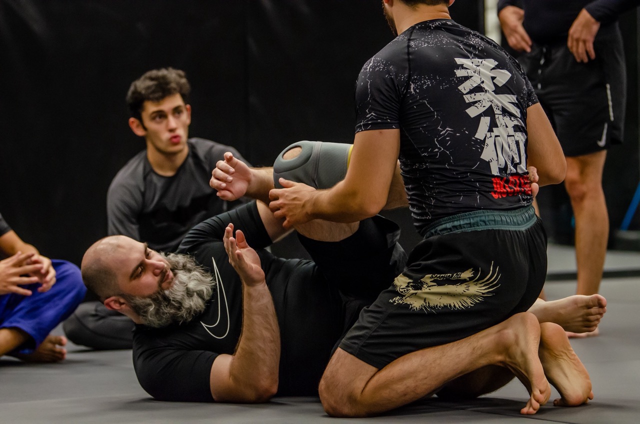 Wrestlers drilling takedowns on the main mats